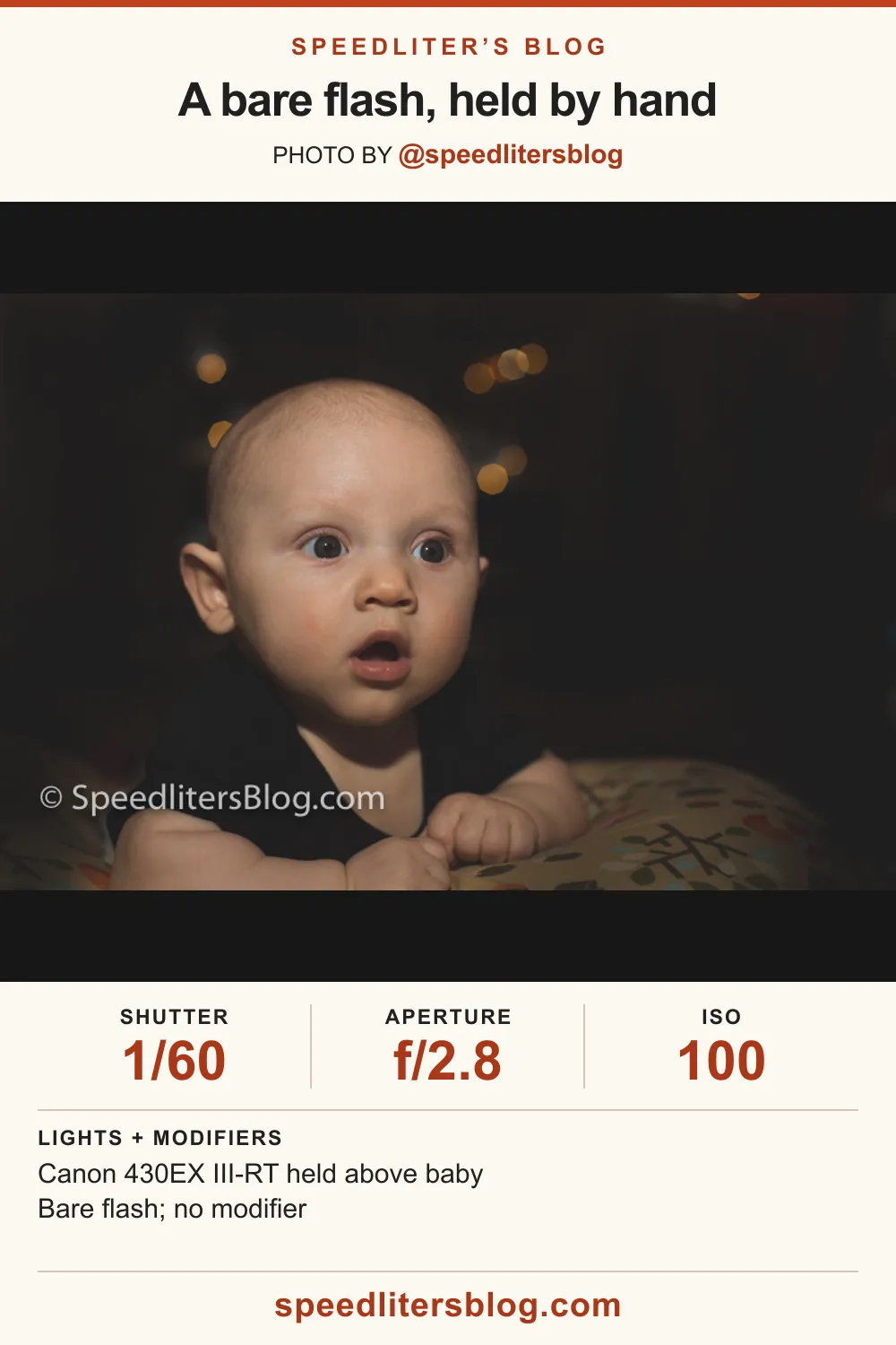 Wide-eyed baby lying on a pillow, lit by bare speedlite with bokeh behind