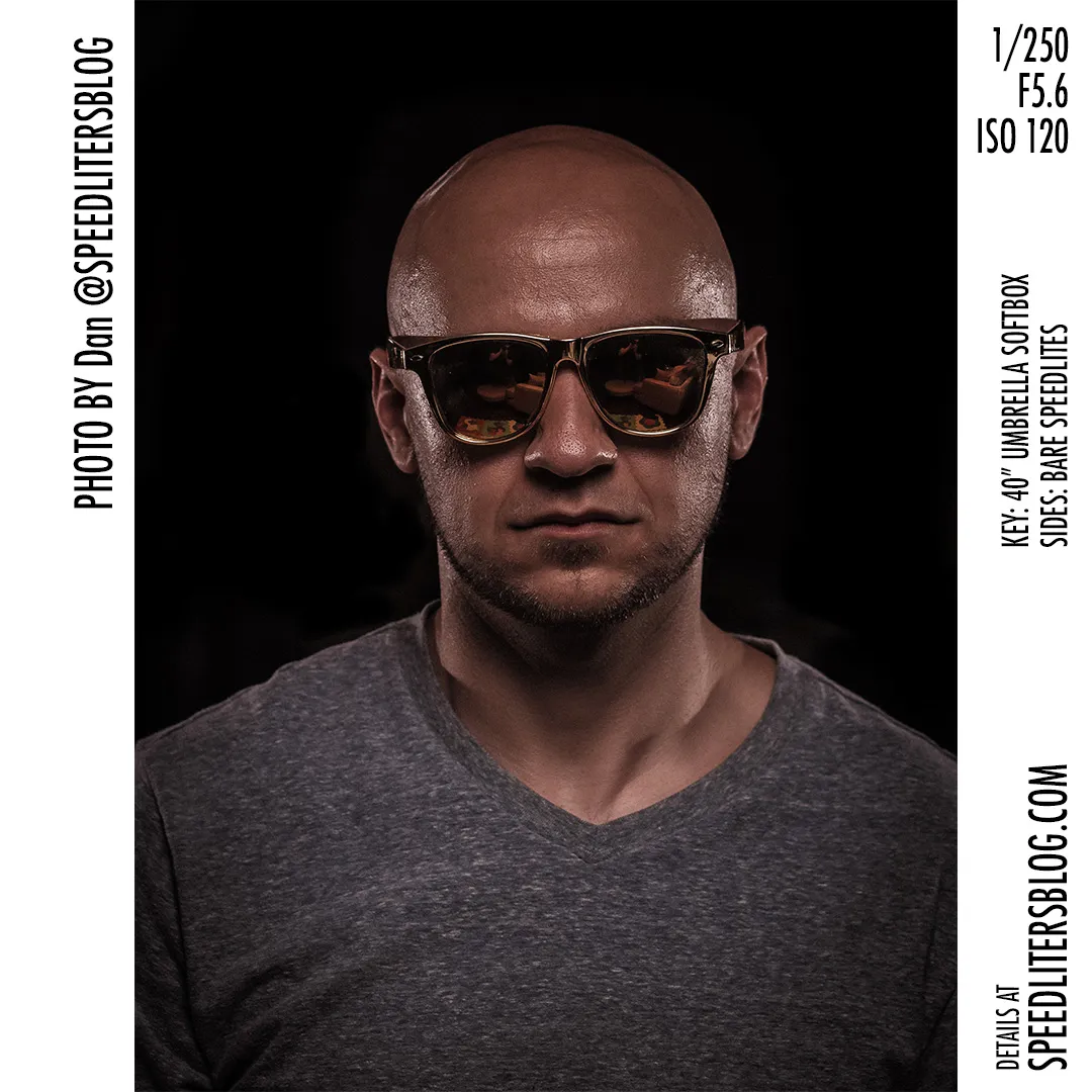 Dramatic three-speedlite portrait of a bald man in sunglasses against a black background