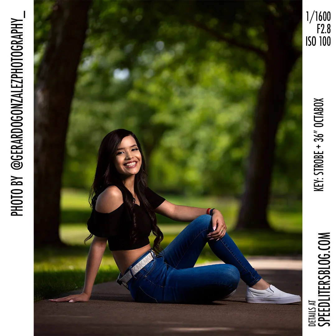 High school senior sitting in a shaded park and smiling, lit by an octabox, by Gerardo Gonzalez
