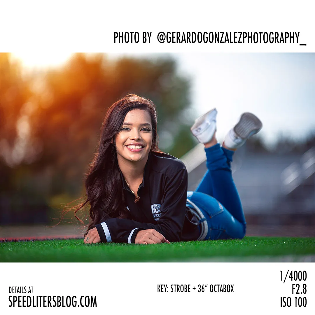 Senior lying on a football field smiling, backlit by the sun, by Gerardo Gonzalez