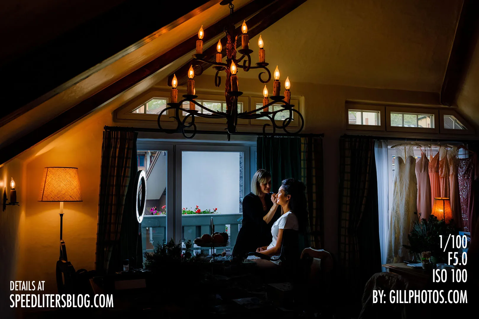 Bride having her makeup done under a chandelier in a cabin, by Gillespie Photography