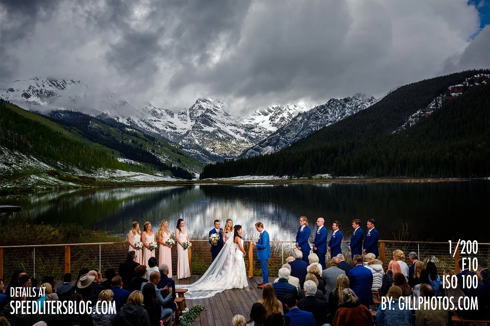 Wide view of a mountain lake wedding ceremony under stormy skies, by Gillespie Photography