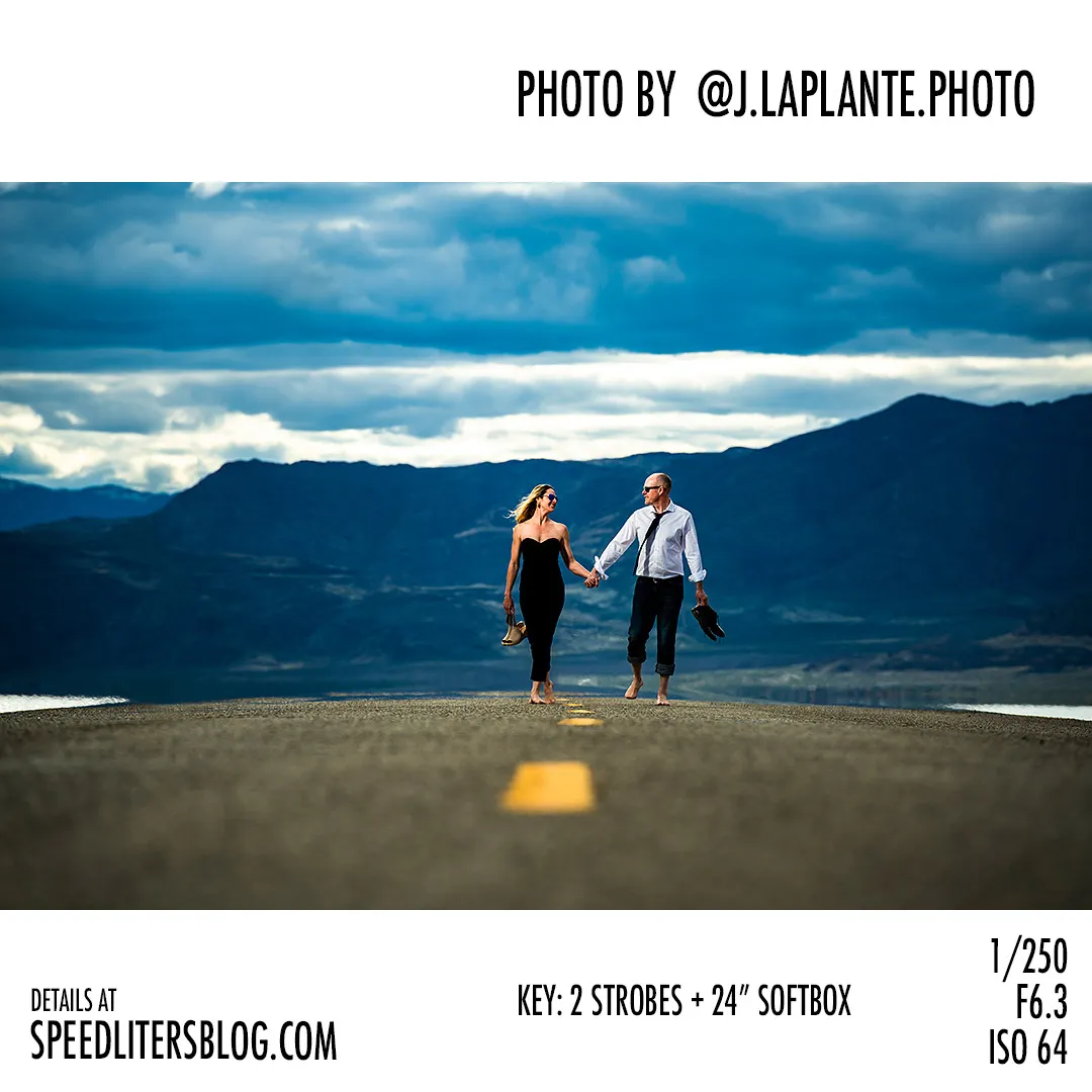 Couple in party clothes walking barefoot down a desert highway, by J La Plante