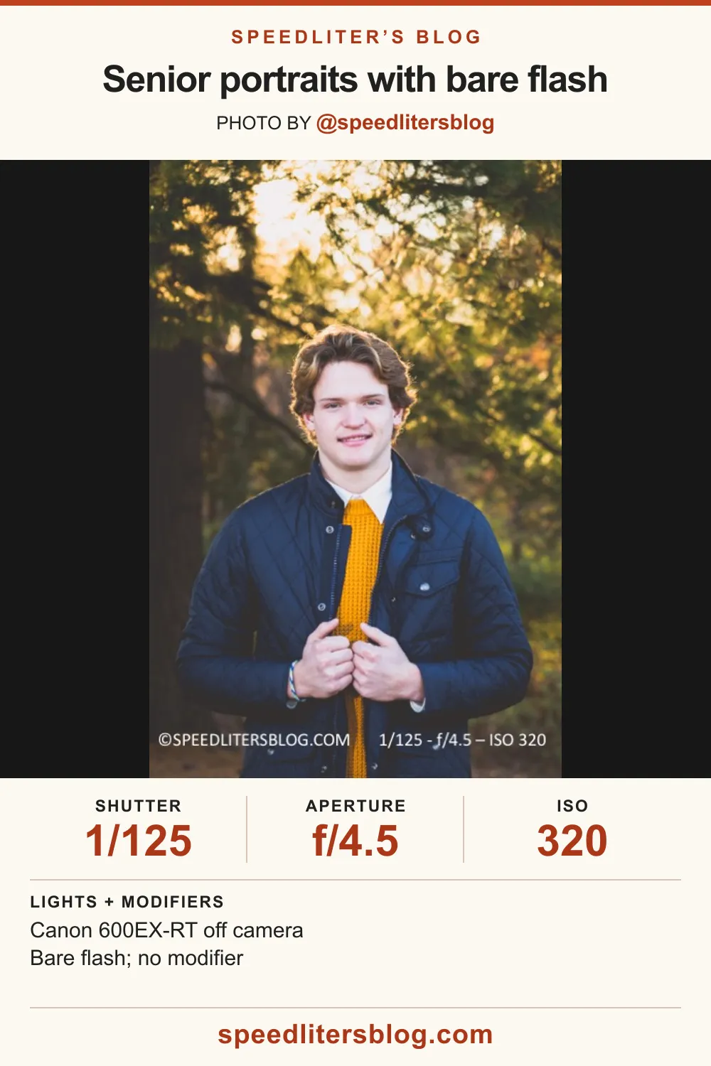 High school senior in a quilted jacket smiling in a fall forest, lit by a bare speedlite