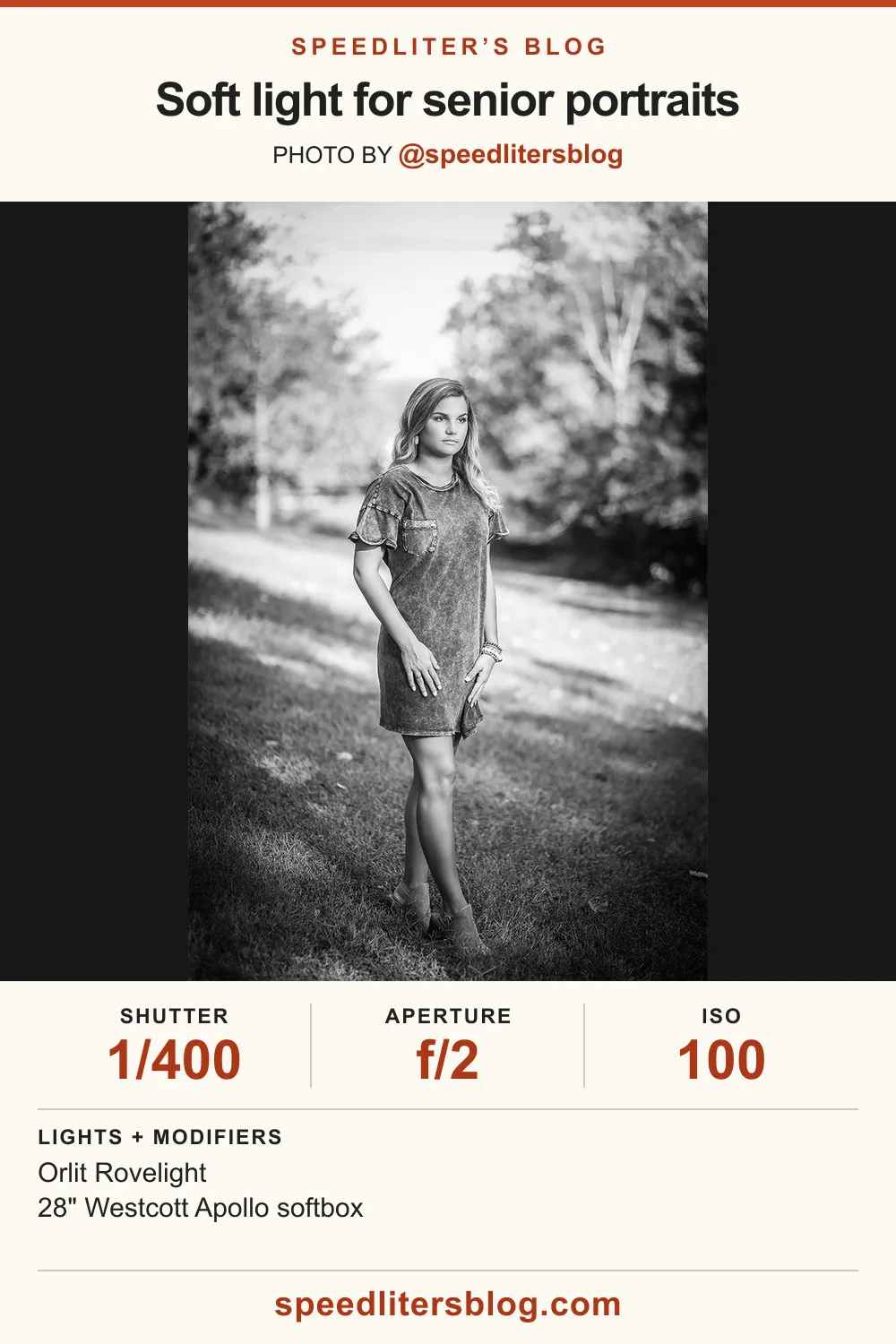 Black-and-white photo of a senior girl in a T-shirt dress standing in a field
