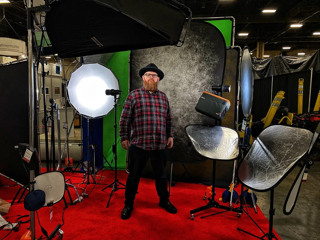 Walter van Dusen standing in the Lastolite by Manfrotto headshot booth at a trade show