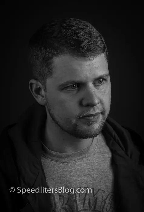 Black-and-white headshot of a man looking off camera